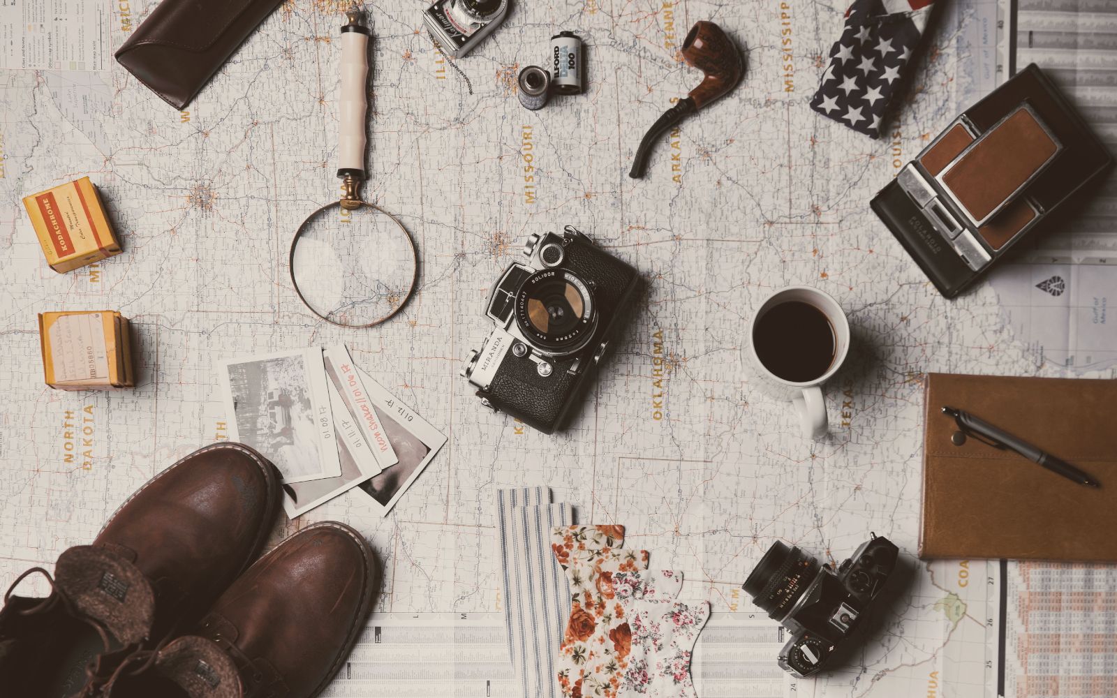 Vintage photography gear laid on map